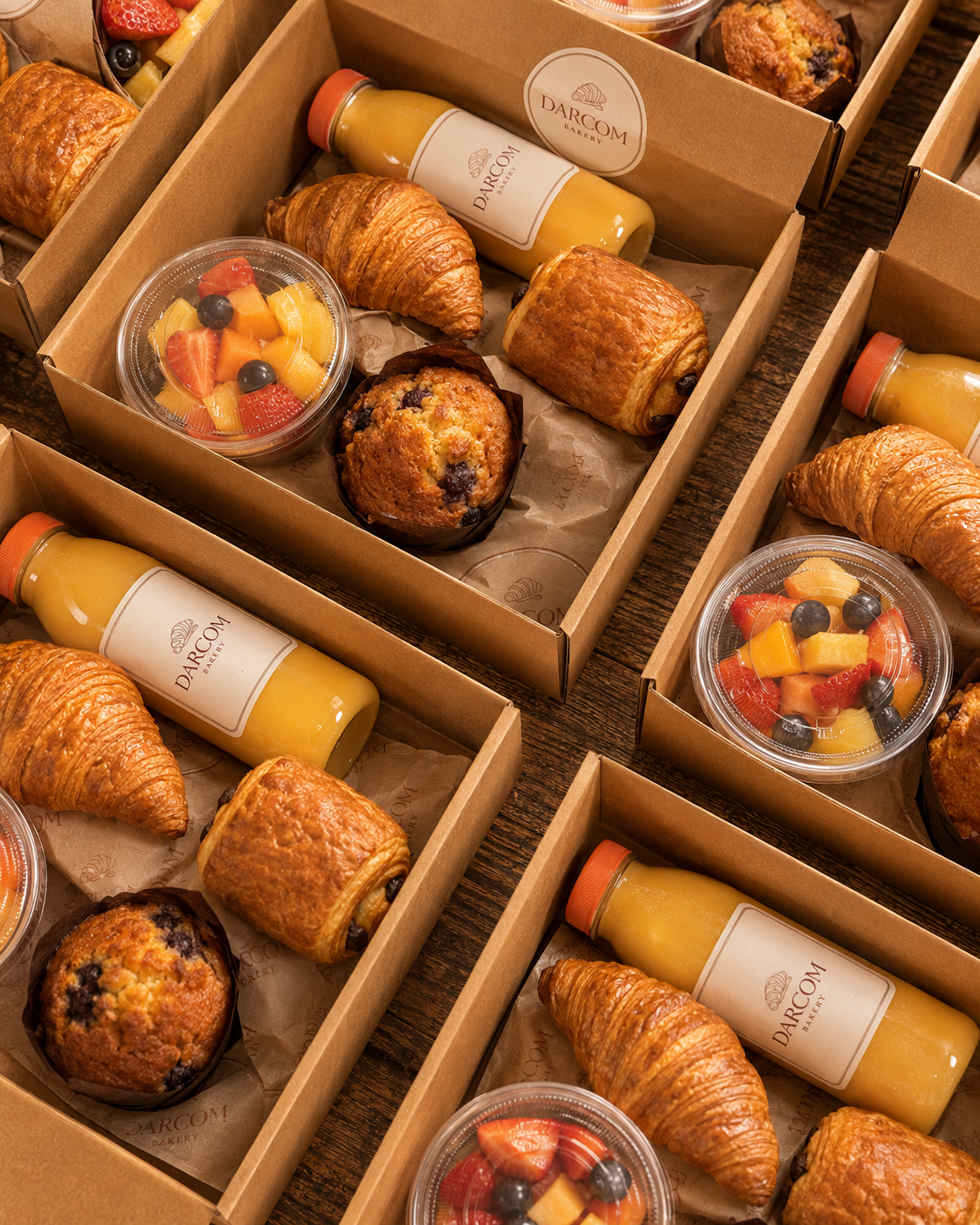Darcom Bakery continental breakfast boxes with pastries, fruit, and beverages